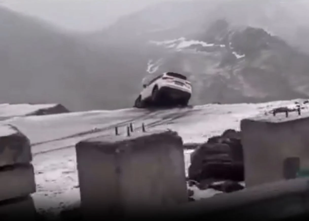 Terrifying moment car dangles over cliff sparking frantic rescue mission