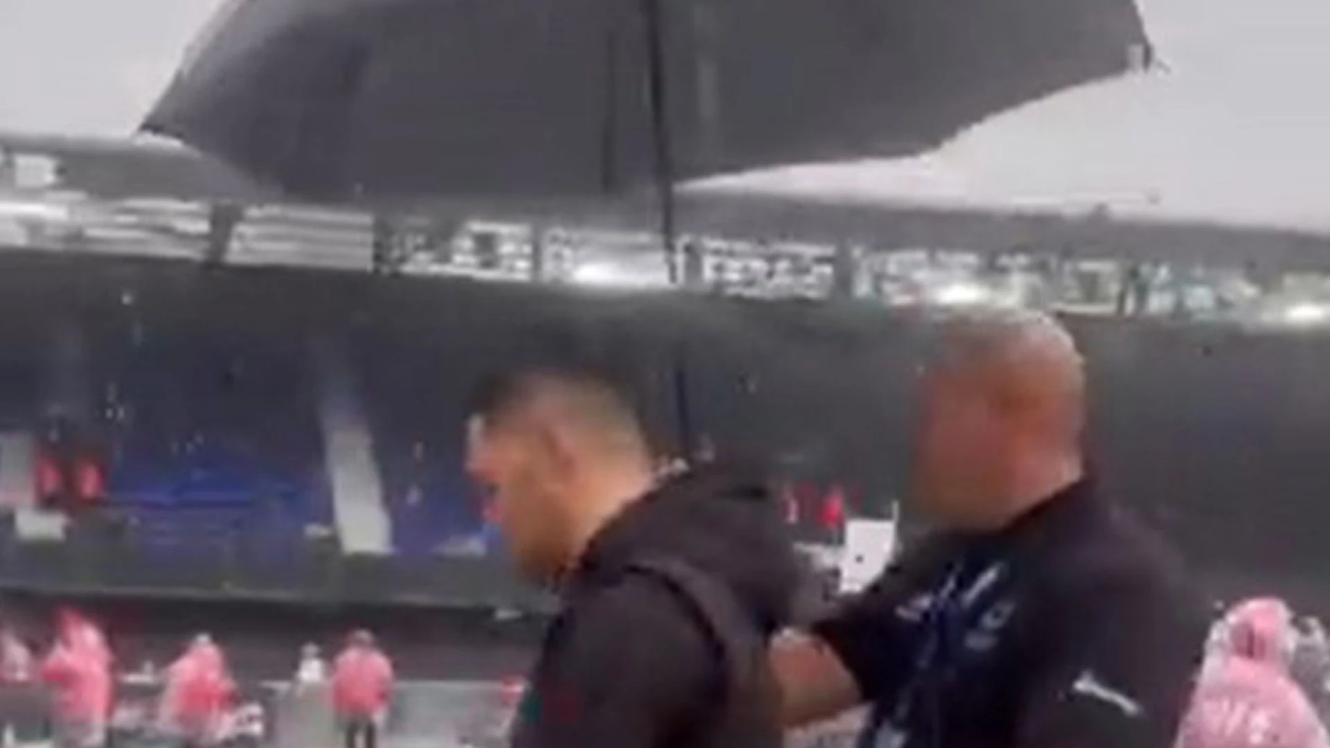Boxer walks to ring with an UMBRELLA as rain pours down at Portman Road fight