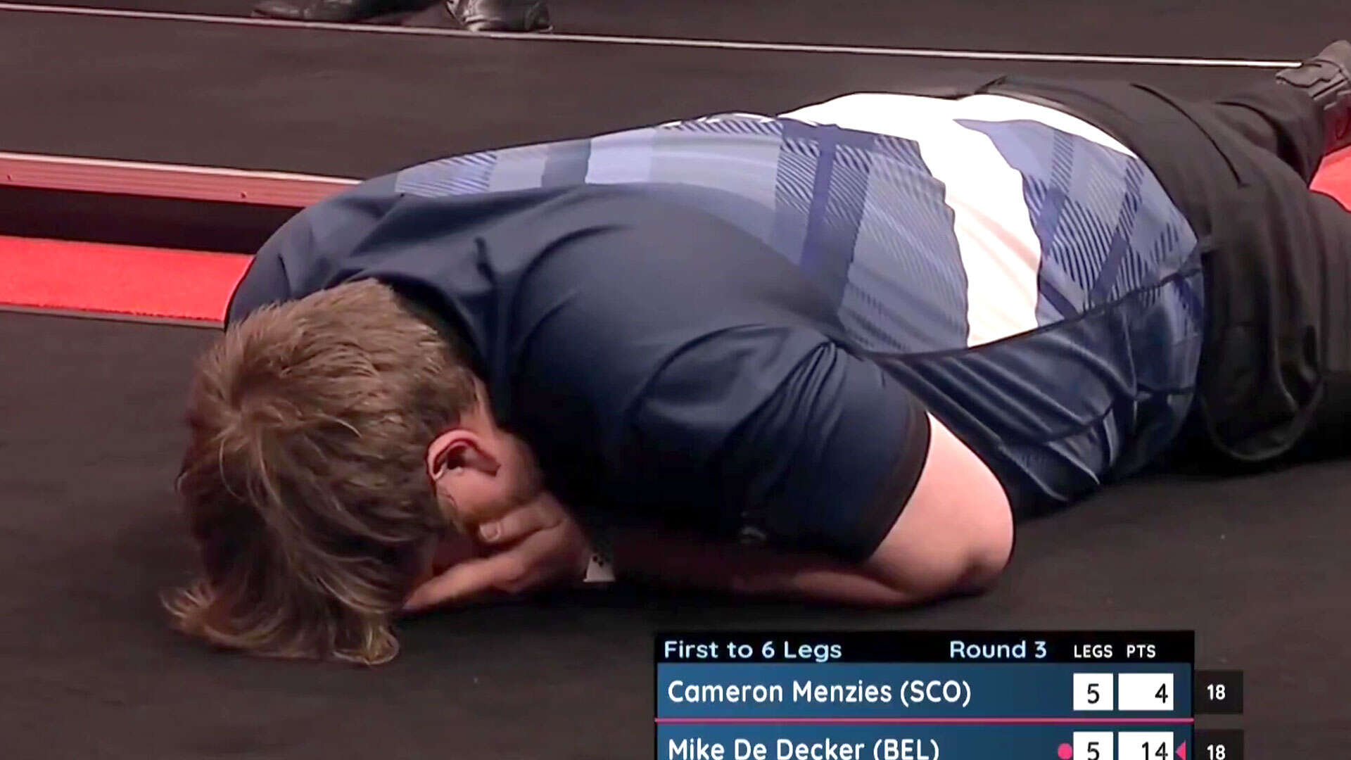 Menzies collapses to the floor after 'miscount of the century' on match dart