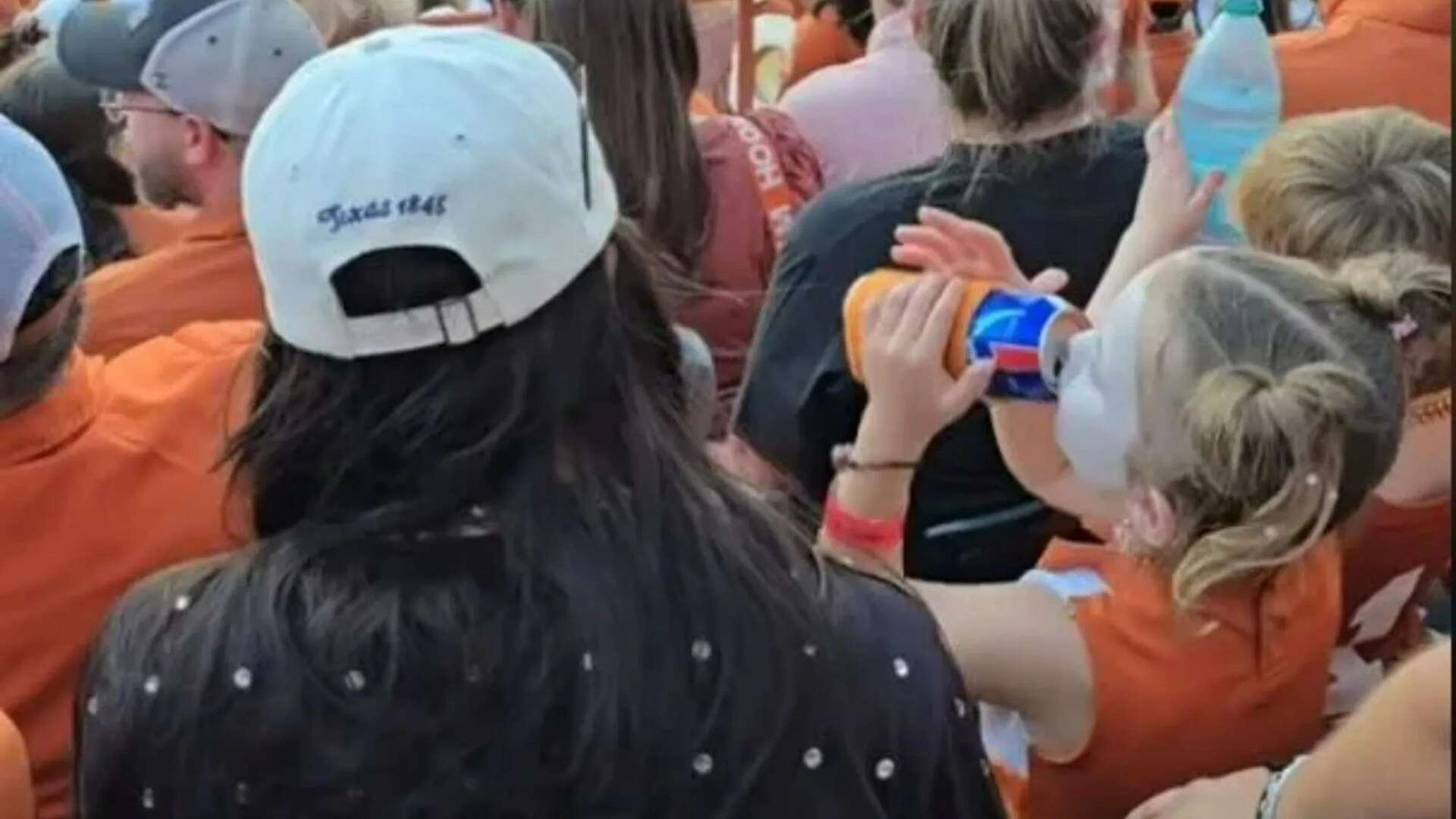 Watch socking moment toddler appears to drink BEER at football game