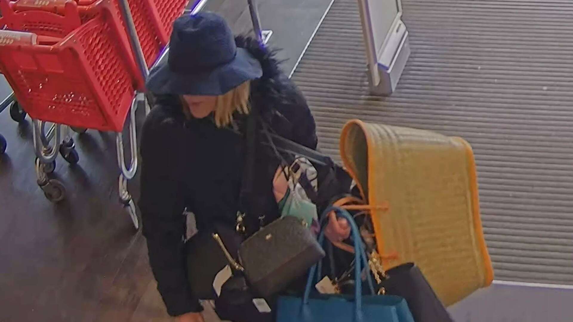 Moment 'one-woman crimewave' flees store laden with stolen bags in hat disguise