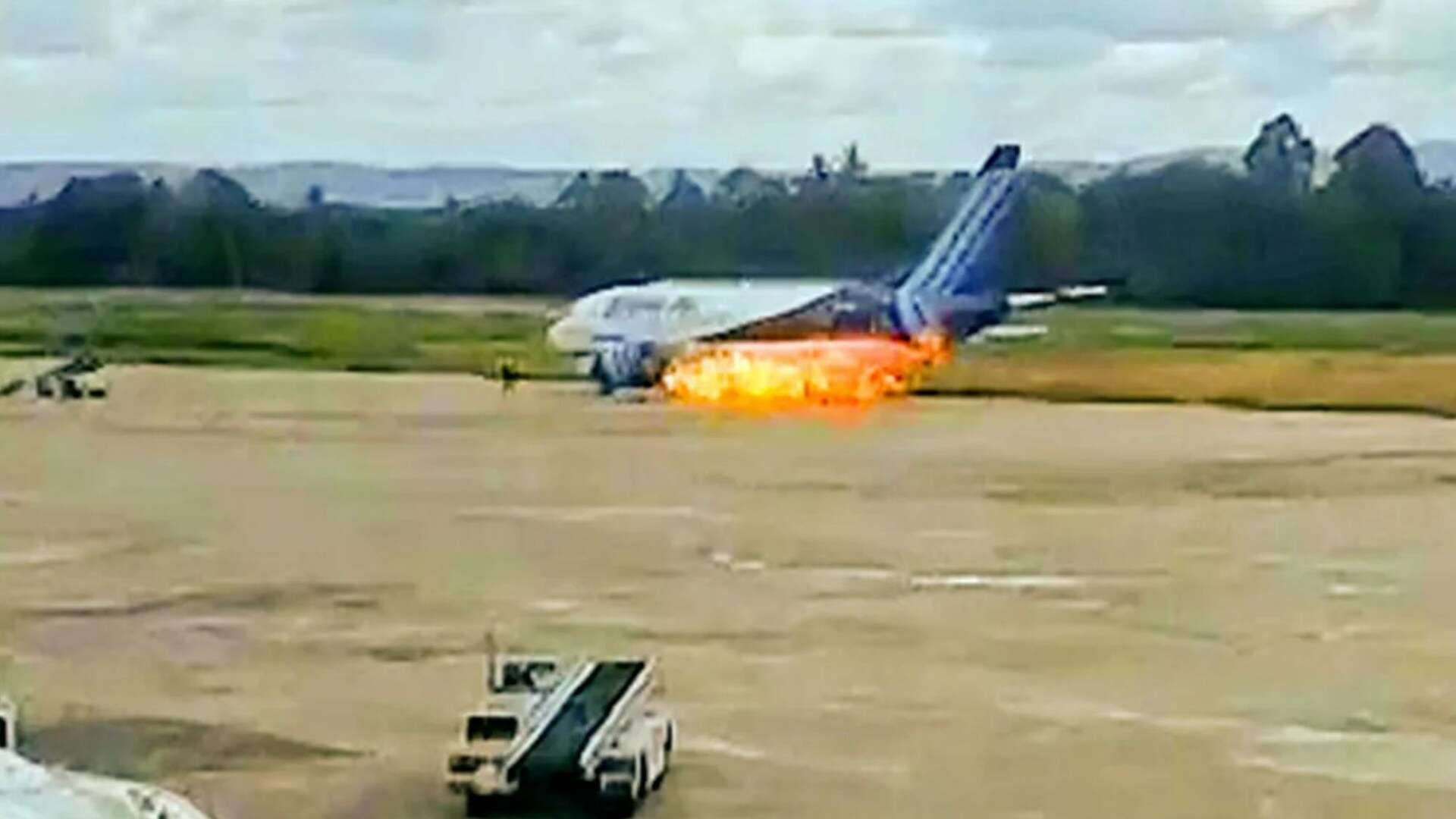 Watch as fire erupts from plane's engine as passengers leap from emergency exit