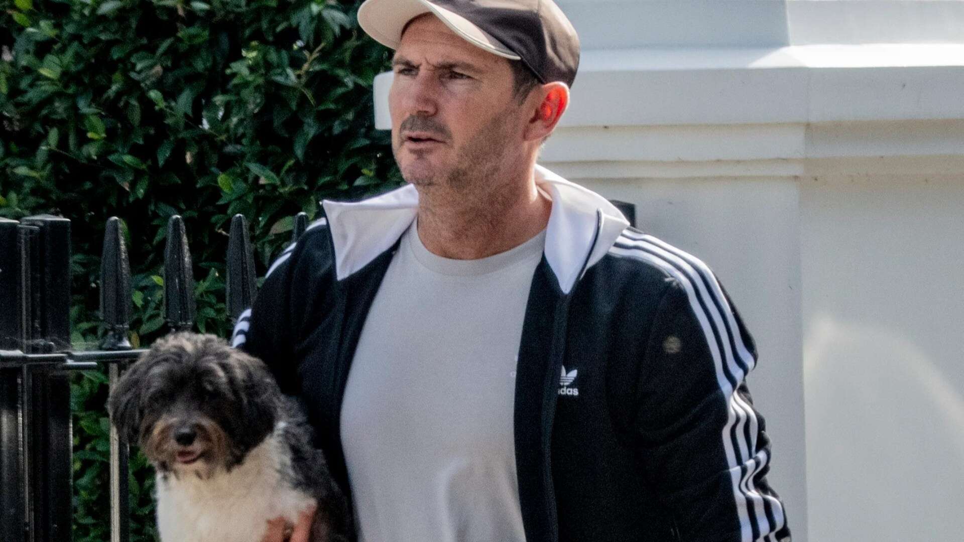 Chelsea legend Frank Lampard carries adorable puppy near his London home