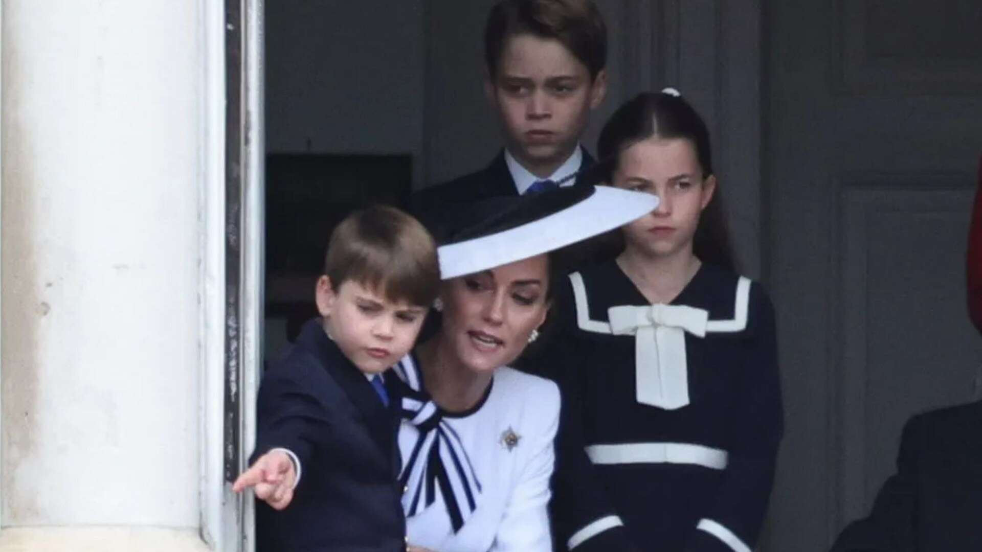 Cheeky Louis plays with curtain cords & adoring mum Kate smiles as pair parade