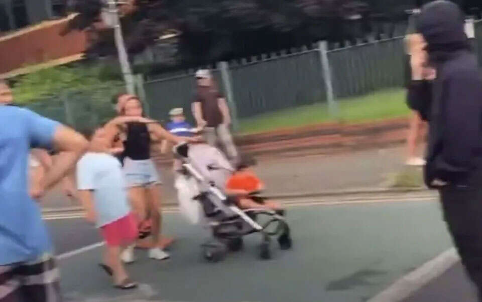 Shock moment mum, 21, pushing baby in pram joins baying mob outside migrant hotel