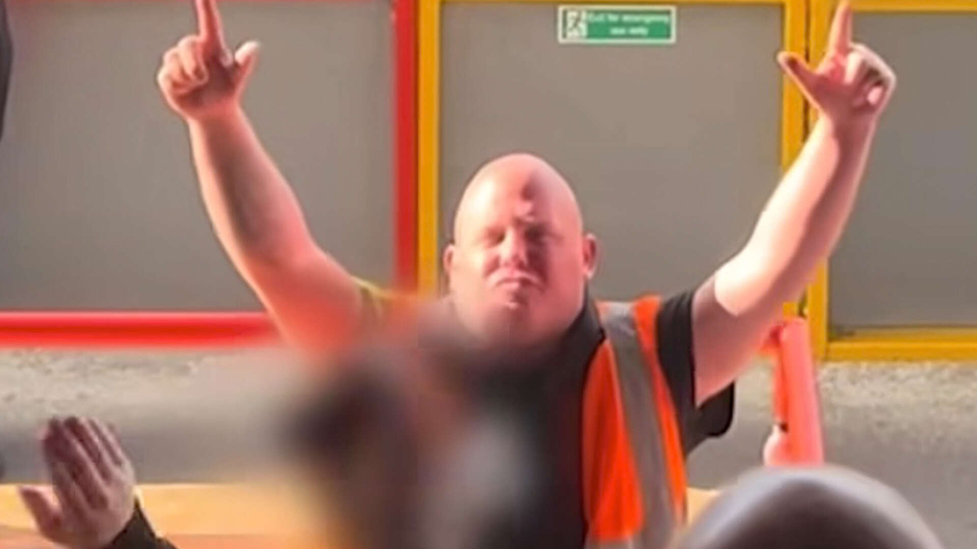 Brilliant moment steward who looks like darts icon is serenaded by footie fans