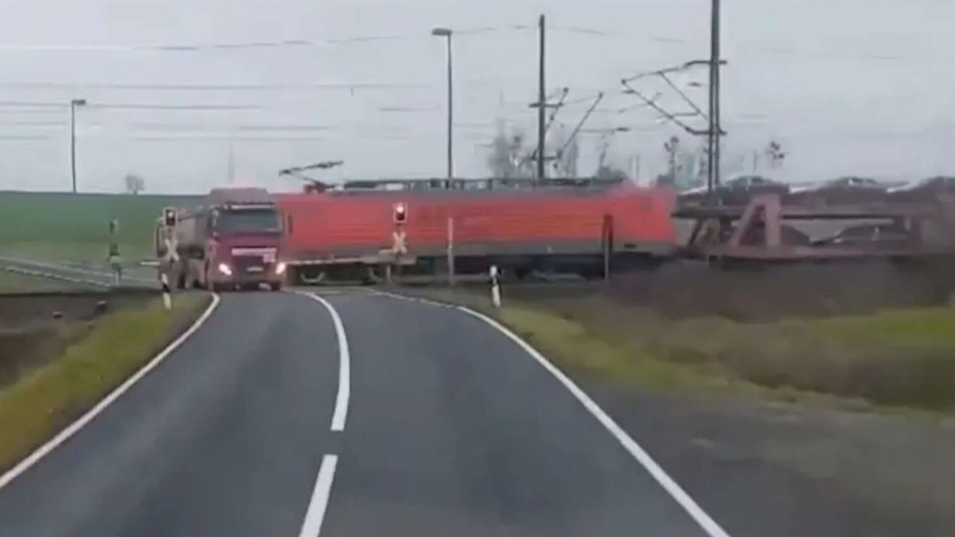 Watch as freight train smashes into truck SECONDS before driver escapes