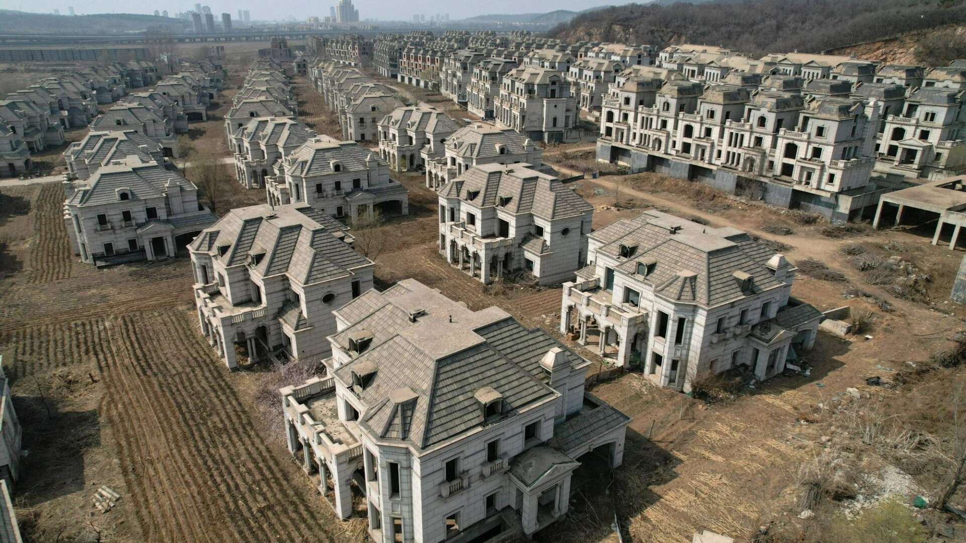 Inside China’s ‘Ghost Town of Mansions’ with lavish homes reclaimed by FARMERS