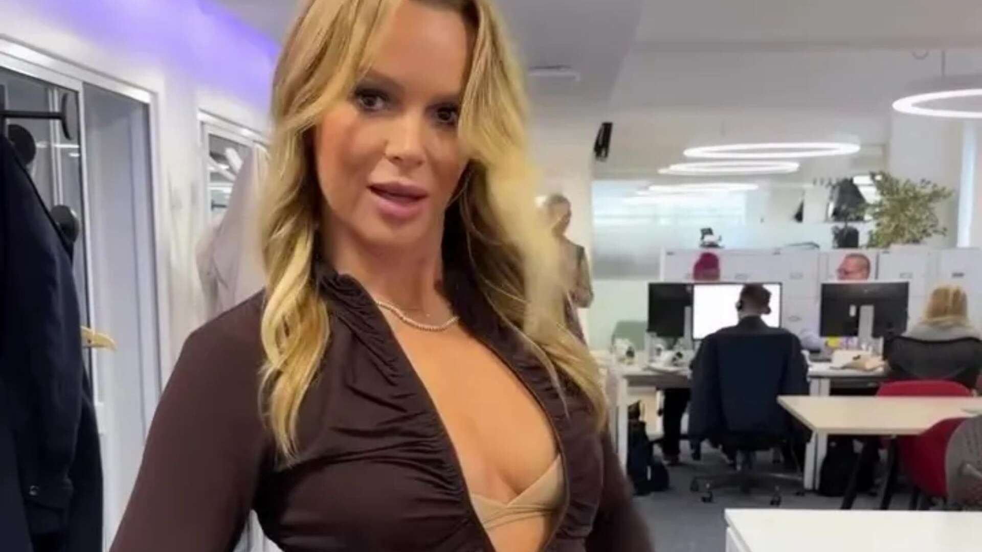 Amanda Holden unzips her top to flash her bra in saucy new video