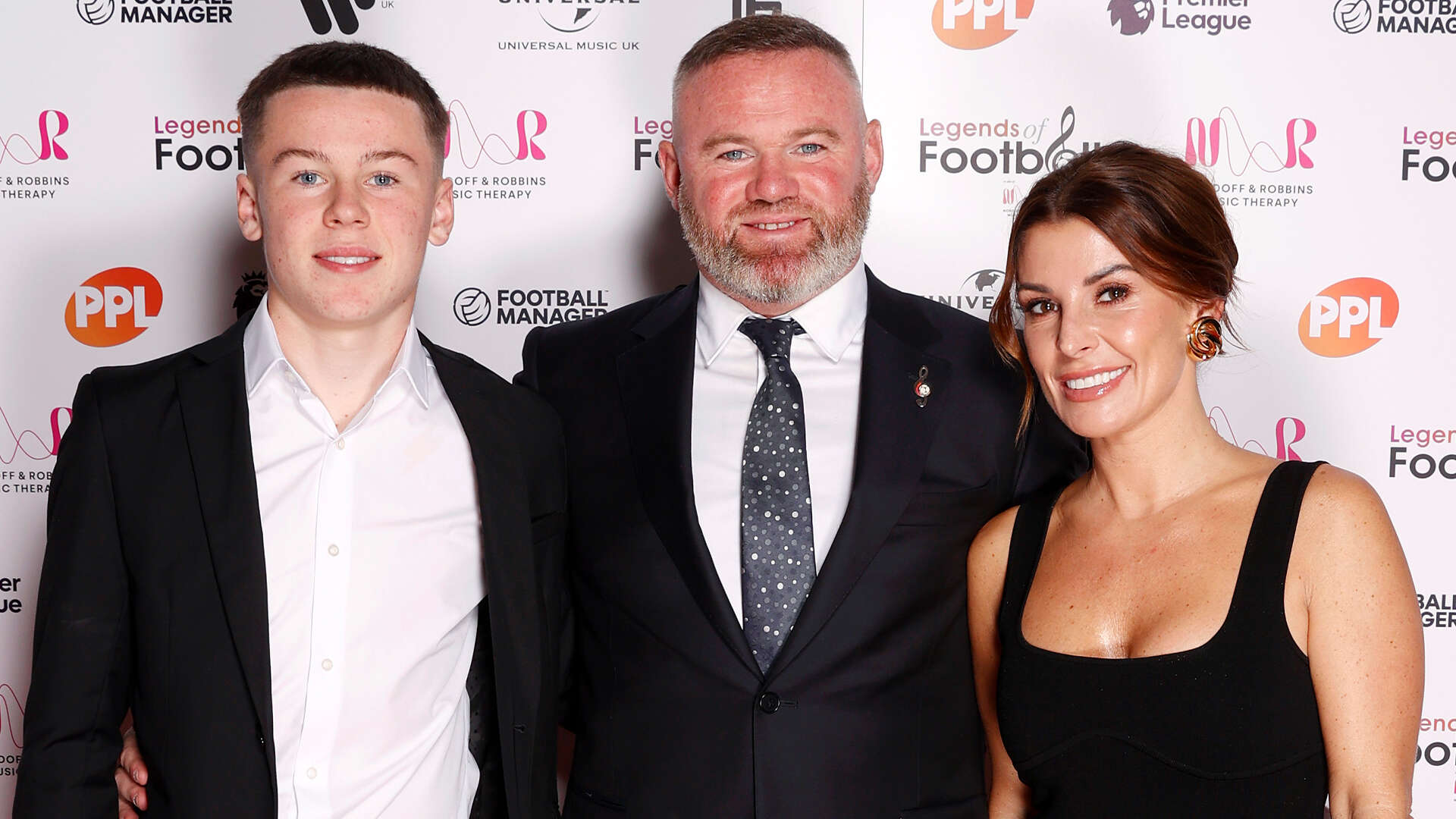 Rooney poses with glam wife Coleen & Man Utd star son Kai, 14, as he wins award