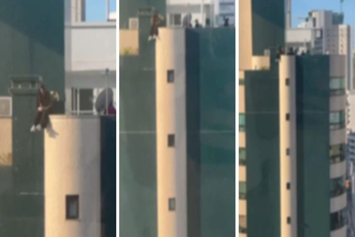 Adolescente arrisca a vida sentada em topo de prédio em SC. Vídeo