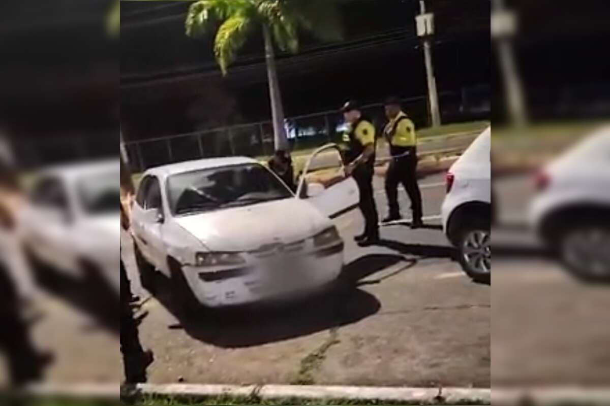 Agente do Detran-DF puxa motorista de carro e o joga no chão. Vídeo