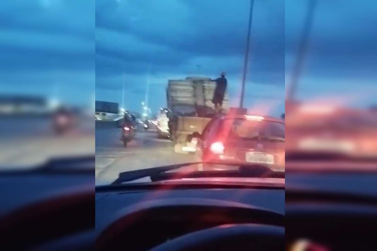 Vídeo: torto de tanta carga, caminhão é flagrado com homem pendurado