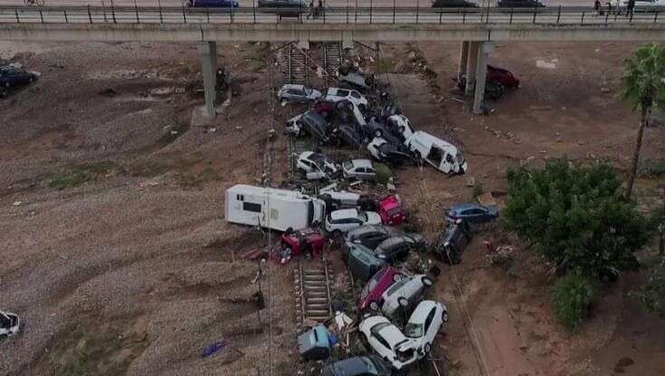 Alluvione in Spagna, le carcasse di auto sui binari nelle immagini dal drone