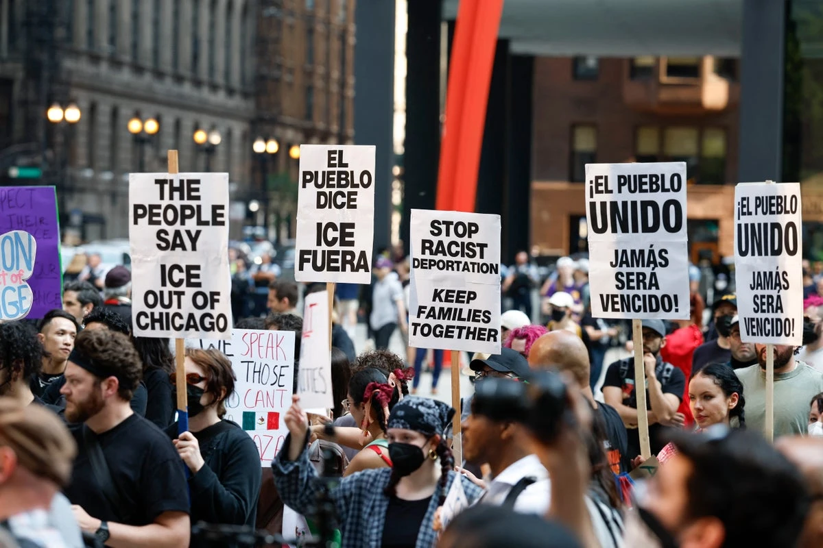 Woman charged after she drove through anti-ICE protesters, police say