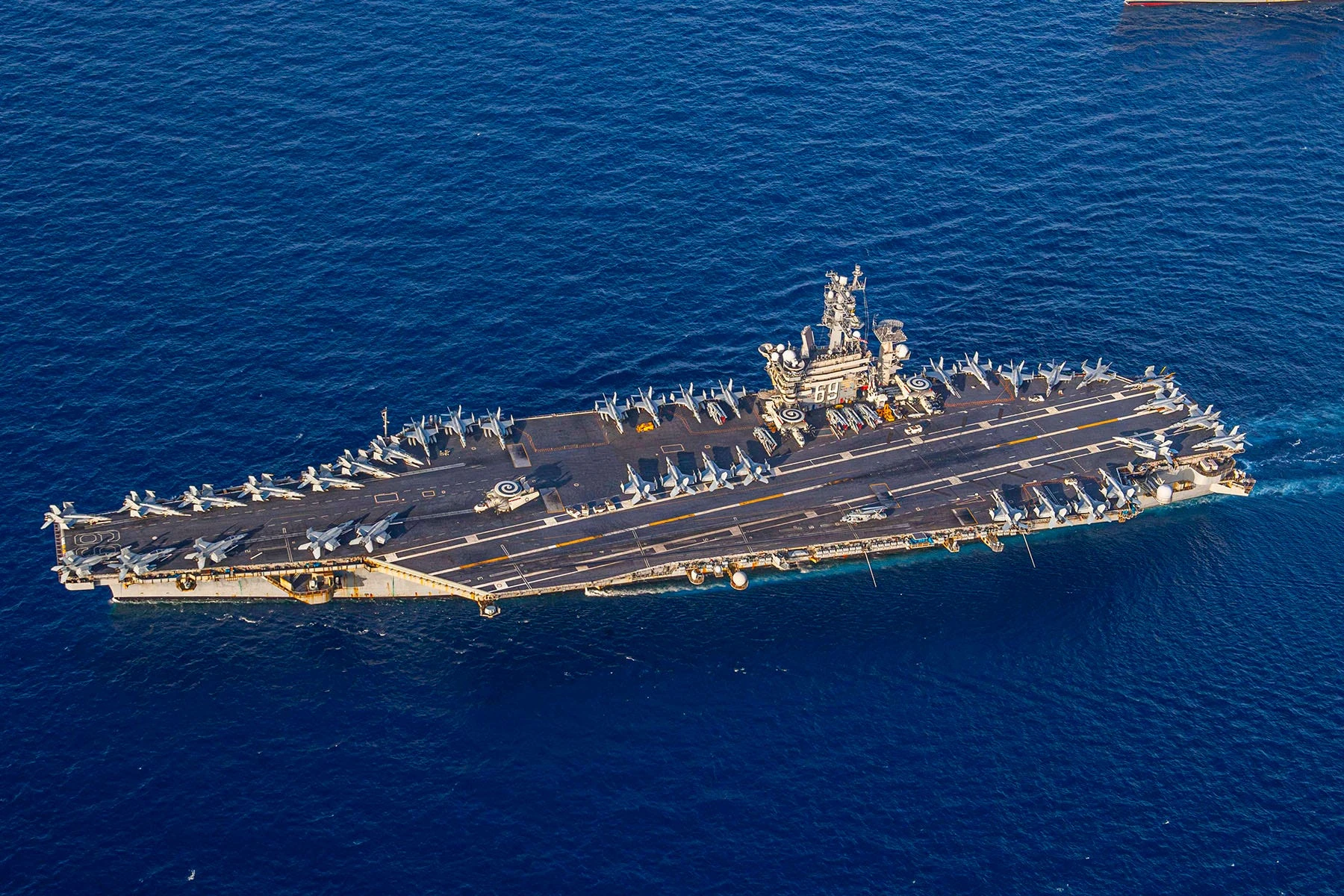 The US Navy carrier strike group fighting off Houthi missiles is staying in the Red Sea for now