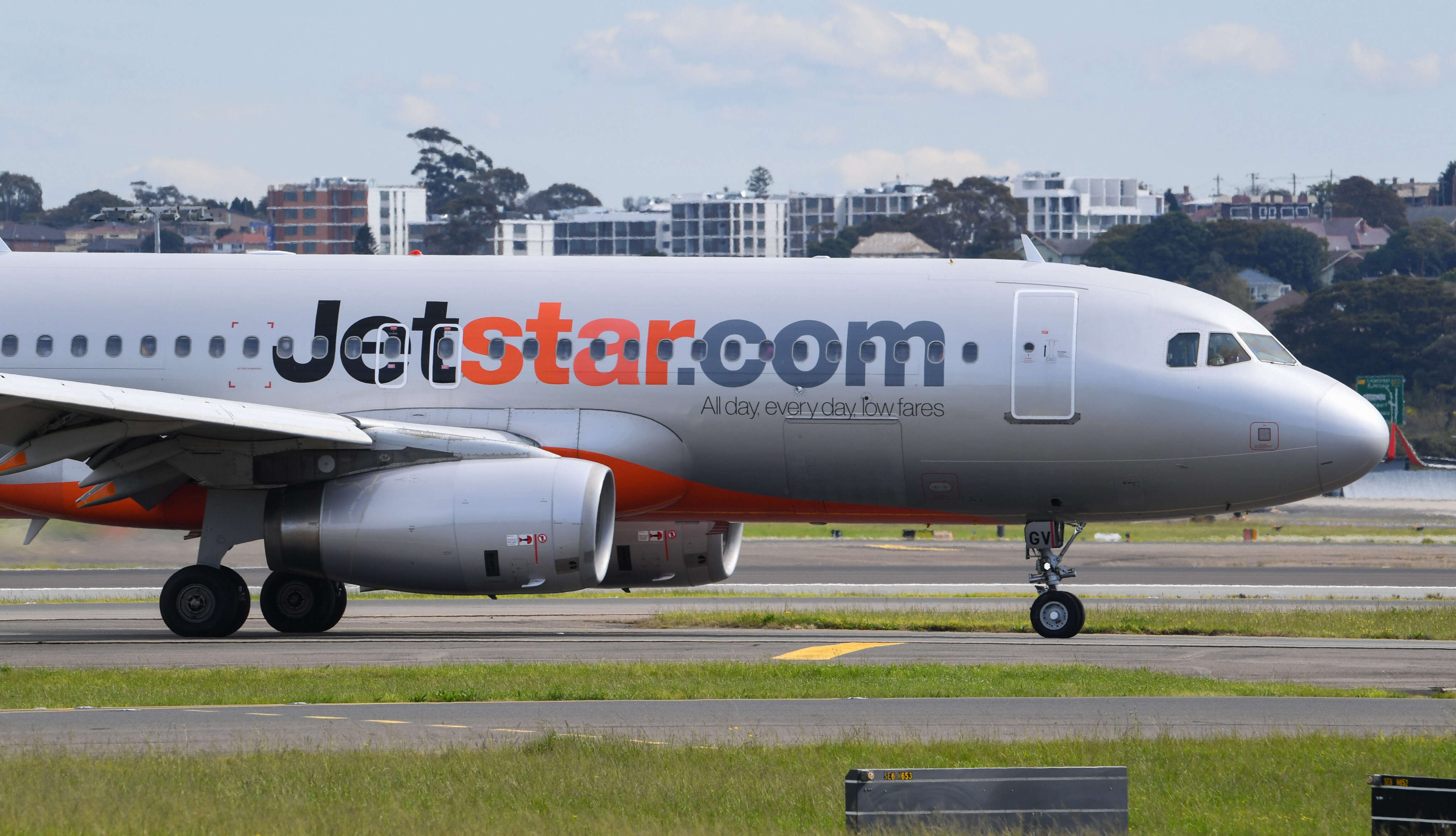 A man in Australia was arrested after opening a plane's emergency exit and climbing onto the wing 