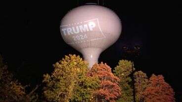 Town Fines Resident For Projecting Trump Sign Onto Water Tower