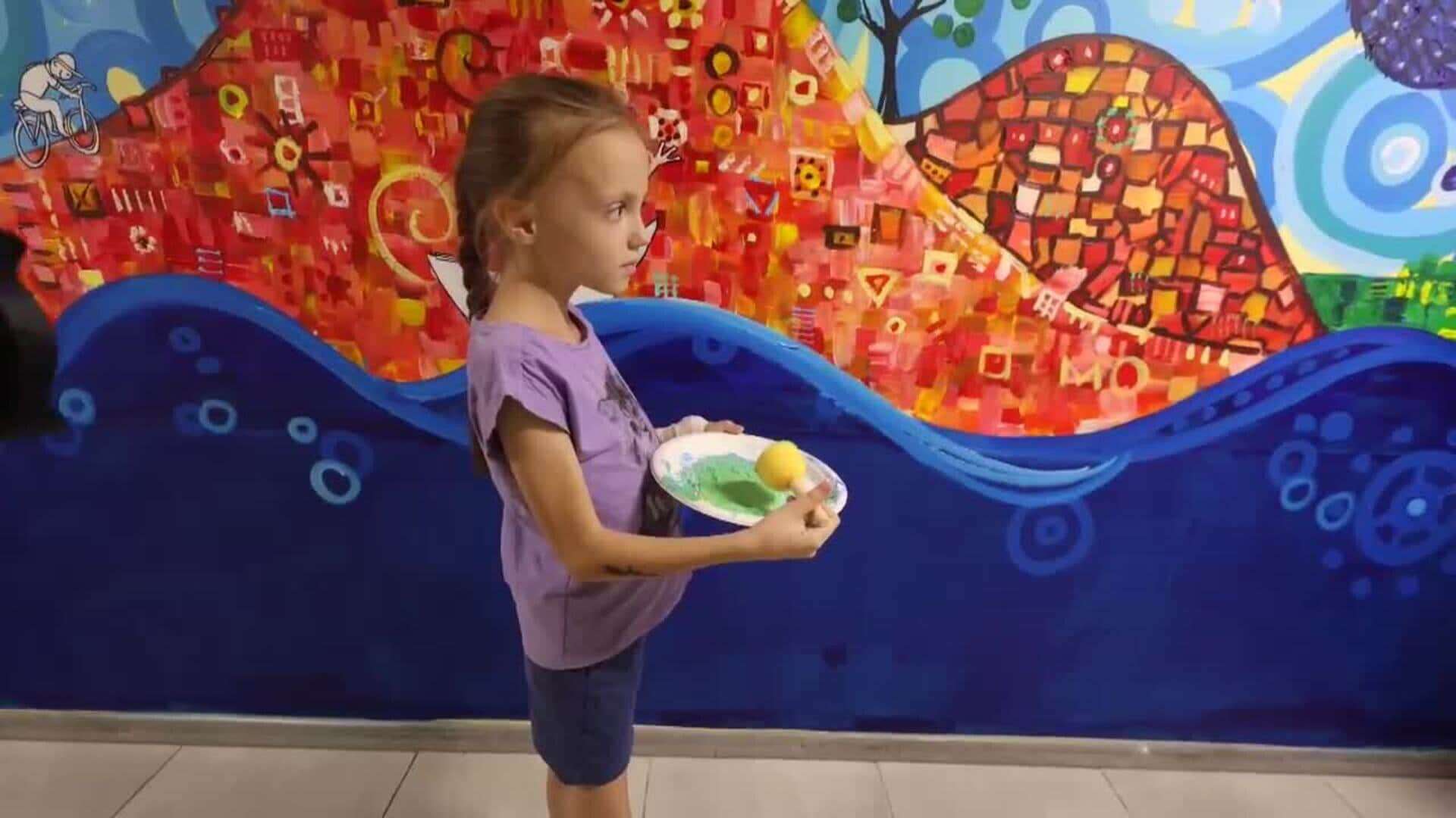 La artista israelí Zoe Sever decora junto a unos niños un muro en un refugio antiaéreo de Járkov