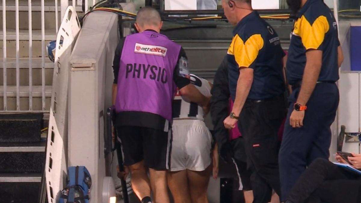 Pies young gun carried off ‘in a lot of pain’ five minutes into match