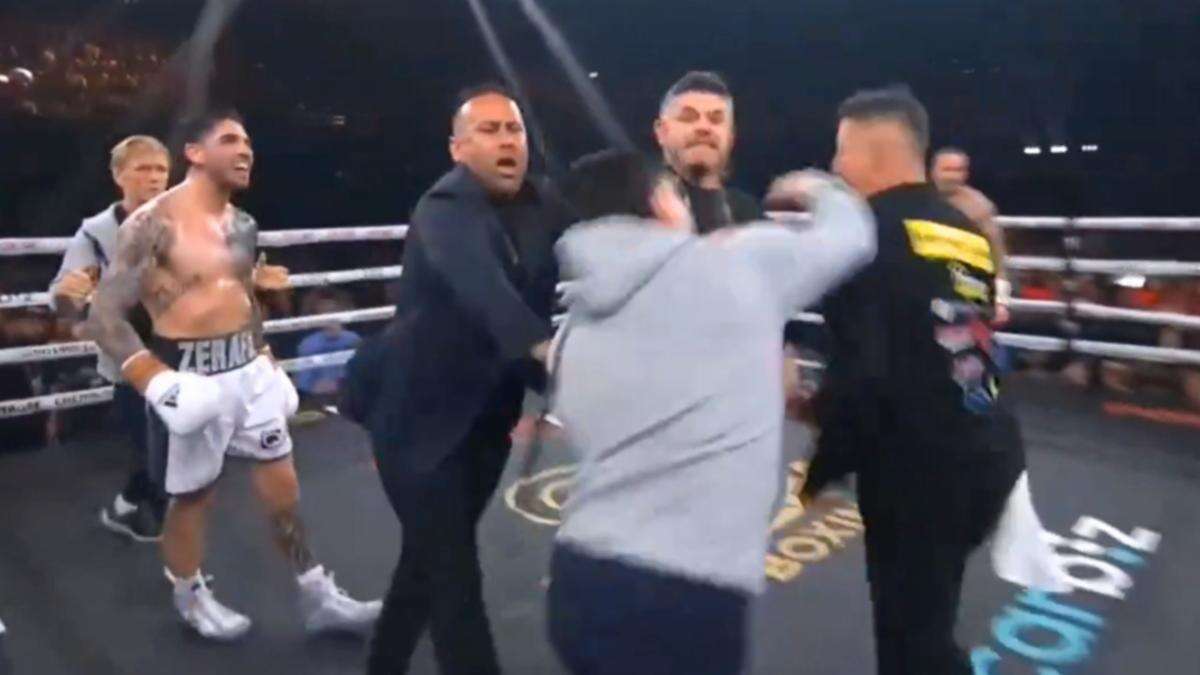 Blockbuster fight descends into chaos as trainer punched in the face