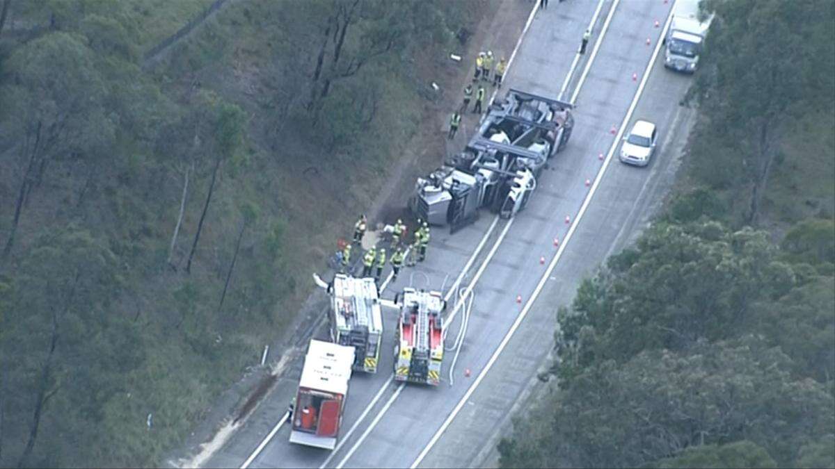 Traffic chaos as semi-trailer carrying six vehicles collides with car in southwest Sydney