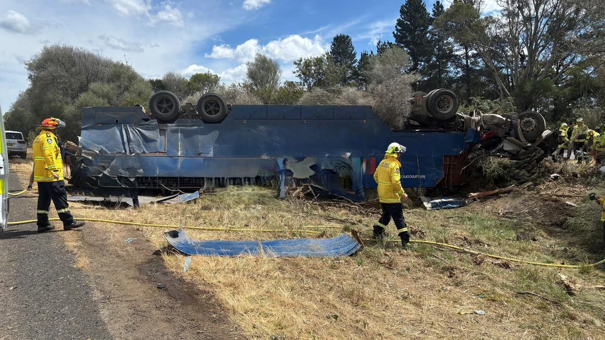 Driver trapped for two hours as truck carrying horse float flips on busy highway