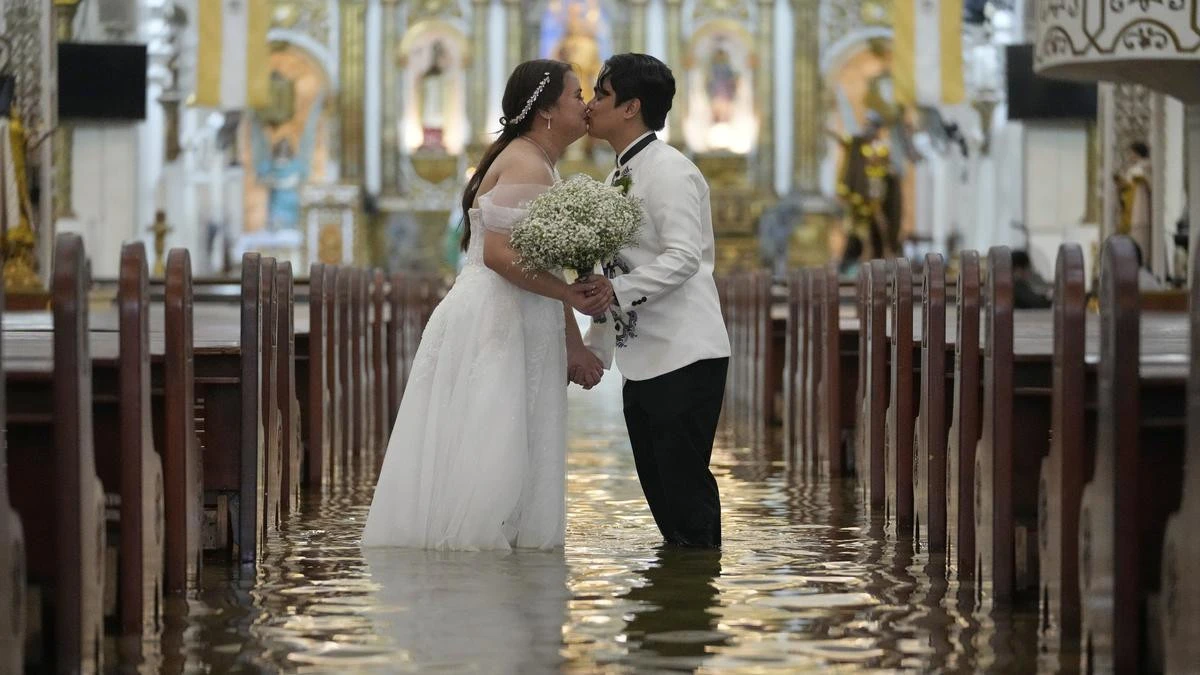 No cold feet: Couple marries in flooded church as rain fails to dampen mood