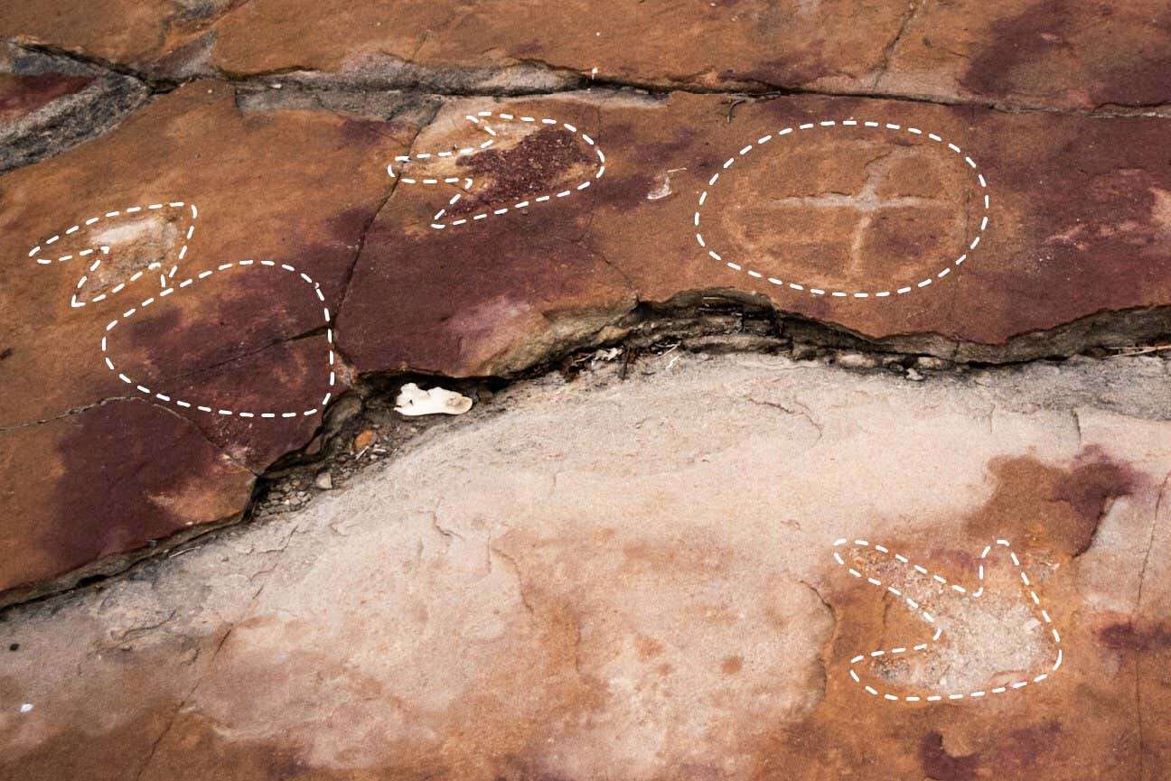 Ancient people carved mysterious symbols near dinosaur footprints