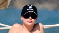 Outer Banks’ Madelyn Cline rocks a teeny red thong bikini and Playboy hat on beach in Spain during movie filming break
