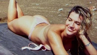 Ashley Roberts risks multiple wardrobe blunders as she sunbathes in undone bikini and poses in dress held up by luck