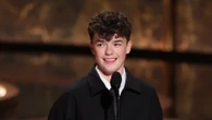 Adolescence star Owen Cooper, 15, becomes youngest male winner of acting Emmy ever as Sydney Sweeney hands him award