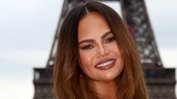 Chrissy Teigen’s amazing comeback to comments she’s wearing what ‘looks like a diaper’ as she attends Paris Olympics