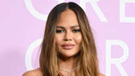 Chrissy Teigen leaves little to the imagination as she poses topless and flaunts her toned figure in video taken at home