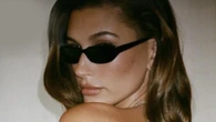 Hailey Bieber goes topless and reveals back tattoo in just cheeky shorts after Justin flees to Iceland