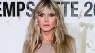 Heidi Klum reveals her bare chest in a completely see-through white dress and debuts jarring new grillz in Paris