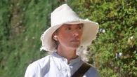 80s movie bombshell, now 58, looks chic in white on walk with dogs in very rare sighting – who is she?
