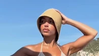 Lori Harvey reveals her six-pack abs in a shimmering gold bikini on boat ride as she declares ‘summer is here’