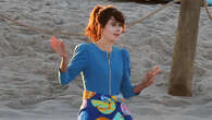 Zooey Deschanel rocks baby blue bathing suit as she runs along beach while filming Merv with Charlie Cox