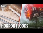 Floodwaters SURGE through shopping centre & leave lorry driver dangling off bridge