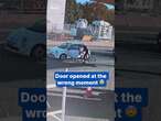 Unlucky cyclist slams into car door