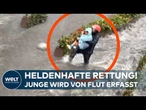 HEFTIGE ÜBERSCHWEMMUNG IN CHINA: Mutige Helfer ziehen Jungen aus reißender Flut in Guangzhou