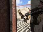 Marines stretch barbed wire at the US-Mexico border