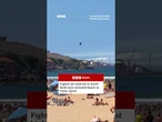Fighter jet swerves to avoid birds near crowded beach in Gijón, Spain. #Spain #BBCNews