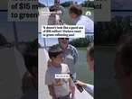 Visitors react to green reflecting pool