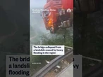 A truck with the driver still inside hangs over the edge of a collapsed bridge in southern China