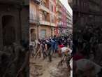 Volunteers sweep water after DEADLY Spain floods