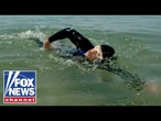 SWIMMING FOR AMERICA'S HEROES: Towing 250 cannonballs across Lake Michigan