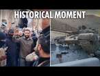 Syrian rebel leader enters Damascus to cheering crowd after Assad toppled & tank cemetery lines road