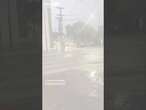 Man bikes through heavy flood waters